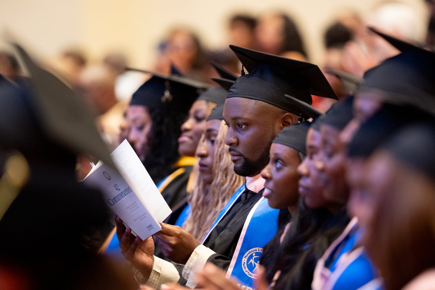 A student reads the program during the graduation ceremony for Morehouse School of Medicine on Saturday, May 16, 2026, in Atlanta. (Ben Gray for the AJC)