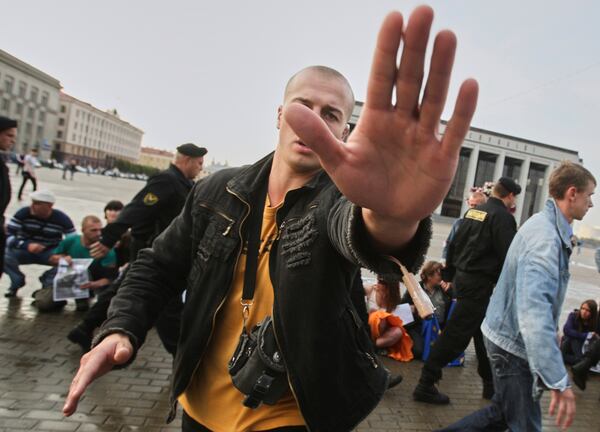 FILE - A plainclothes police officer obstructs a photographer working at an opposition rally in Minsk, Belarus, on Sept. 16, 2009.(AP Photo, File)