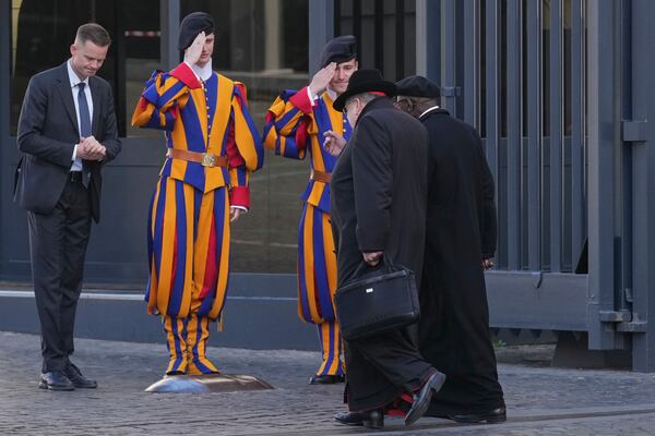 Cardinals, right, arrive for a meeting of cardinals, at the Vatican, Tuesday, April 22, 2025. (AP Photo/Andrew Medichini)