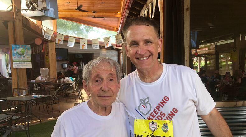 The oldest male runner in The AJC Peachtree Road Race, Lamar Perlis, and his close friend Dr. Peter Donnan after the 2018 race. (Tess DeMeyer/AJC)