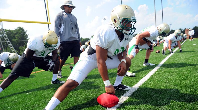 Buford assistant Bryant Appling walks the line of players at the start of football practice Monday, Aug. 1, 2011. Appling made his debut as head coach in 2019, leading the Wolves to a state championship.