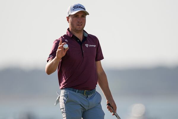Justin Thomas departs the 18th green during the third round of the RBC Heritage golf tournament, Saturday, April 19, 2025, in Hilton Head Island, S.C. (AP Photo/Mike Stewart)