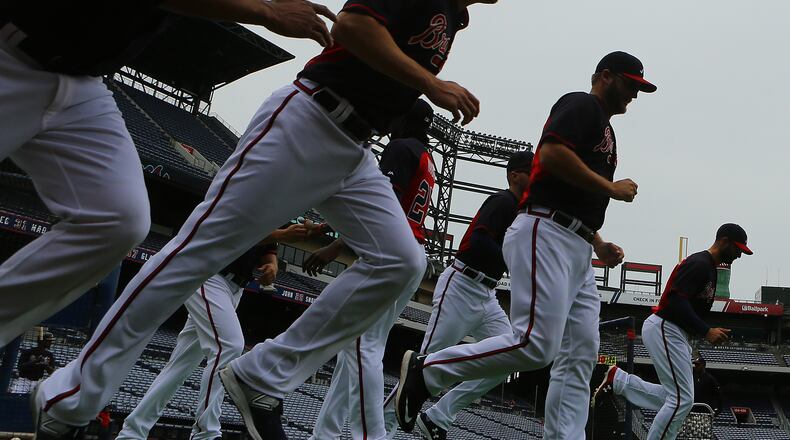 The Braves take the field to loosen up for batting practice before playing the Nationals in a baseball game on Monday, April 27, 2015, in Atlanta. Curtis Compton / ccompton@ajc.com