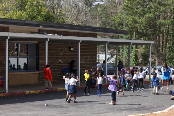 Elementary school students play during their recess in a parking lot at RISE Schools, on Wednesday, Feb. 22, 2023, in East Point, Ga. The RISE Grammar and Prep schools are in jeopardy of being closed by Fulton County Schools. The students play in the parking lot because their playground is under construction. Jason Getz / Jason.Getz@ajc.com)