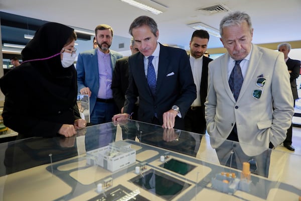 In this photo released by the Atomic Energy Organization of Iran, International Atomic Energy Agency (IAEA) Director General, Rafael Mariano Grossi, center, visits an exhibition of Iran's nuclear achievements, in Tehran, Iran, Thursday, April 17, 2025. (Atomic Energy Organisation of Iran via AP)