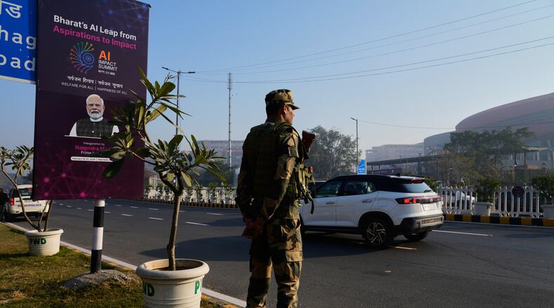 An Indian para-military force soldier stands guard outside the venue of AI-Summit in New Delhi, India, Monday, Feb. 16, 2026. (AP Photo/Manish Swarup)