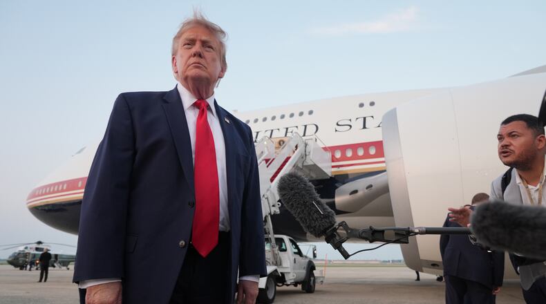 President Donald Trump speaks to reporters as he exits Air Force One at Joint Base Andrews, Md., after attending the World Cup final soccer match, Sunday, July 19, 2026. (AP Photo/Jacquelyn Martin)