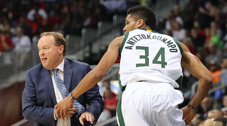 Bucks’ Giannis Antetokounmpo gets tangled up with Hawks head coach Mike Budenholzer in a NBA basketball game on Sunday, Jan. 15, 2017, in Atlanta. Curtis Compton/ccompton@ajc.com