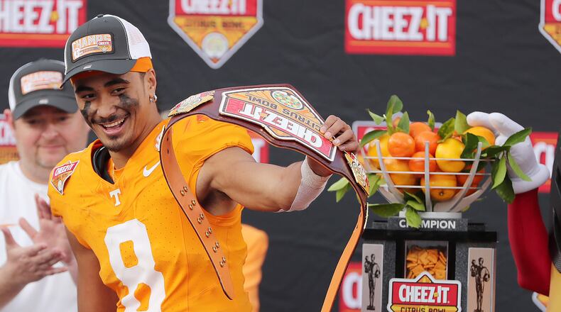 Tennessee quarterback Nico Iamaleava celebrates with the championship trophy after winning the Cheez-It Citrus Bowl college football game of Tennessee versus Iowa at Camping World Stadium in Orlando on Monday, Jan. 1, 2024. Tennessee won the game 35-0. (Stephen M. Dowell/Orlando Sentinel/TNS)