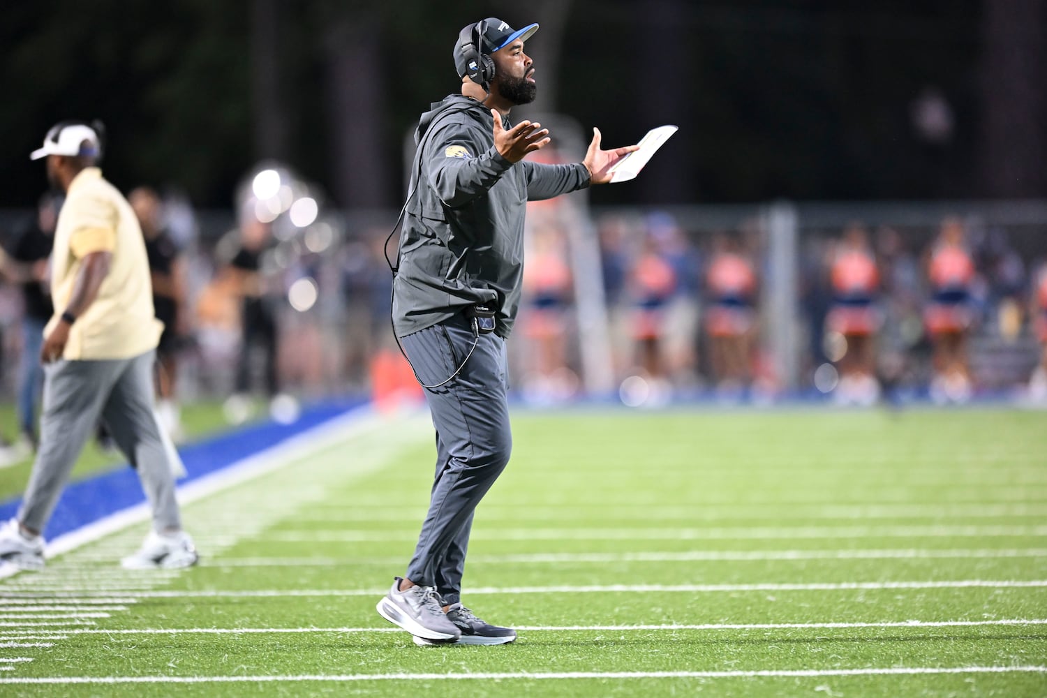 McEachern head coach Kareem Reid reacts to a referee’s call during the first half of play Friday, August 22, 2025 at McEachern.  (Daniel Varnado/For the Atlanta Journal-Constitution)