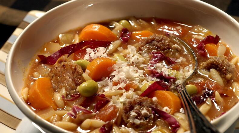 A refrigerator rich with odds and ends is the source for this soup, built on smoked turkey sausage, carrots, onion, tomatoes, pasta and edamame. (Chicago Tribune/TNS)