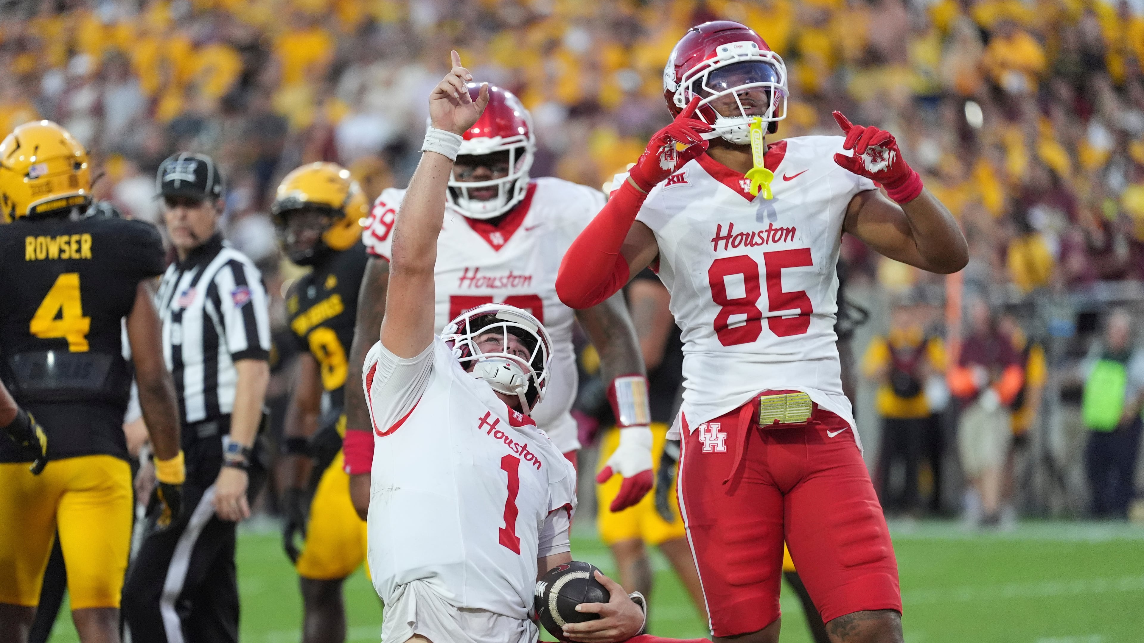 Houston quarterback Conner Weigman (1) celebrates his touchdown against Arizona State with Houston tight end Traville Frederick Jr. (85) during the first half of an NCAA college football game Saturday, Oct. 25, 2025, in Tempe, Ariz. (AP Photo/Ross D. Franklin)