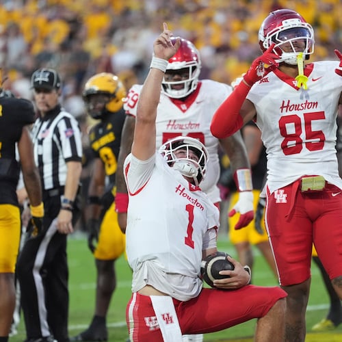 Houston quarterback Conner Weigman (1) celebrates his touchdown against Arizona State with Houston tight end Traville Frederick Jr. (85) during the first half of an NCAA college football game Saturday, Oct. 25, 2025, in Tempe, Ariz. (AP Photo/Ross D. Franklin)