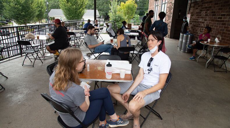Lara Hulbert (left) and Sean McTagne eat brunch on the patio of Krog Street Market. The latest pandemic relief bill includes several items that will benefit restaurants. Steve Schaefer for The Atlanta Journal-Constitution