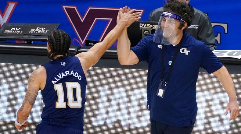 Georgia Tech guard Jose Alvarado (10) gives a high-five to head coach Josh Pastner after their 80-75 win over Florida State in the ACC championship game Saturday, March, 13, 2021, in Greensboro, N.C. (Gerry Broome/AP)