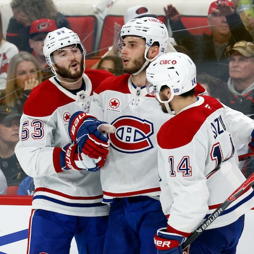 Montréal Canadiens' Juraj Slafkovský (20), center, celebrates his goal with Nick Suzuki (14) and Noah Dobson (53) during the third period in Game 1 of the Eastern Conference finals NHL hockey Stanley Cup playoffs series against the Carolina Hurricanes in Raleigh, N.C., Thursday, May 21, 2026. (AP Photo/Karl DeBlaker)