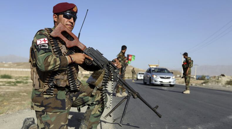 Afghan National Army soldiers stand guard at a checkpoint on the outskirts of Kabul, Afghanistan, Monday, Aug. 21, 2017. President Donald Trump is planning to deliver his first formal address to the nation since taking office Monday as he reveals to the nation his strategy for the war in Afghanistan. (AP Photo/Rahmat Gul)