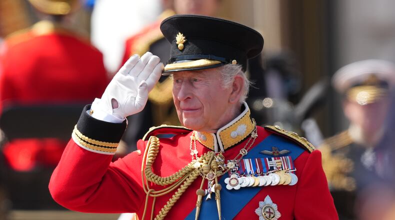 Britain's King Charles III salutes the troops outside Buckingham Palace during Trooping The Colour, the King's annual birthday parade, in London, Saturday, June 13, 2026. (AP Photo/Kirsty Wigglesworth)