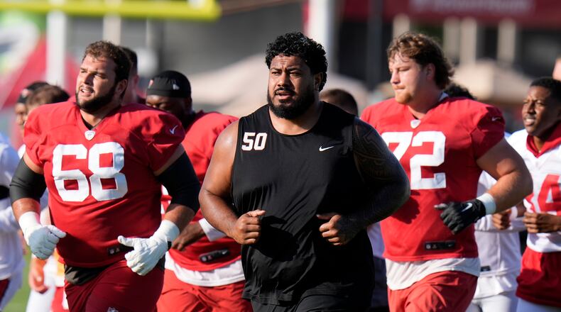 Tampa Bay Buccaneers guard Ben Bredeson (from left), defensive tackle Vita Vea (50) and offensive tackle Luke Haggard (72) run during Back Together Weekend. The enormous Vea often requires a double-team block on most plays. (Chris O'Meara/AP)