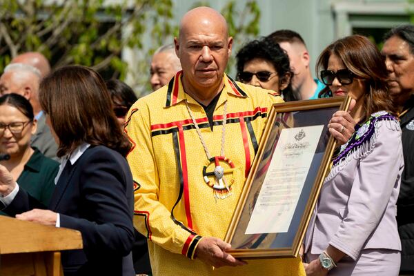 Seneca Nation president J. Conrad Seneca carries a proclamation of formal apology from New York Gov. Kathy Hochul on behalf of New York State for its role in operating the Thomas Indian School, Tuesday, May 20, 2025, outside the William Seneca Administration Building in Irving, N.Y. (Libby March/The Buffalo News via AP)