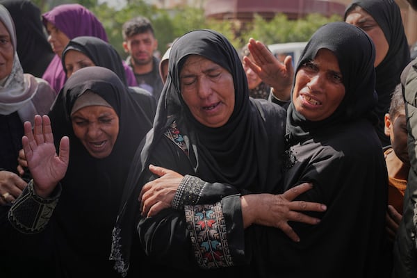 Palestinians mourn during the funeral of Reem Al-Akhras, who was killed while heading to an aid distribution hub, in Khan Younis, Gaza Strip, Tuesday, June 3, 2025. (AP Photo/Abdel Kareem Hana)