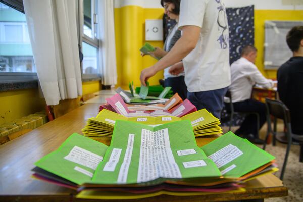 Ballot papers are prepared on a table for referendums on citizenship and job protections, at a polling station in Milan, Italy, Sunday, June 8, 2025. (Claudio Furlan/LaPresse via AP)