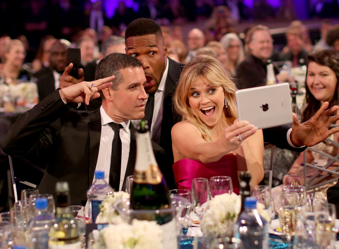 Jim Toth, host Michael Strahan and actress Reese Witherspoon pose for selfies