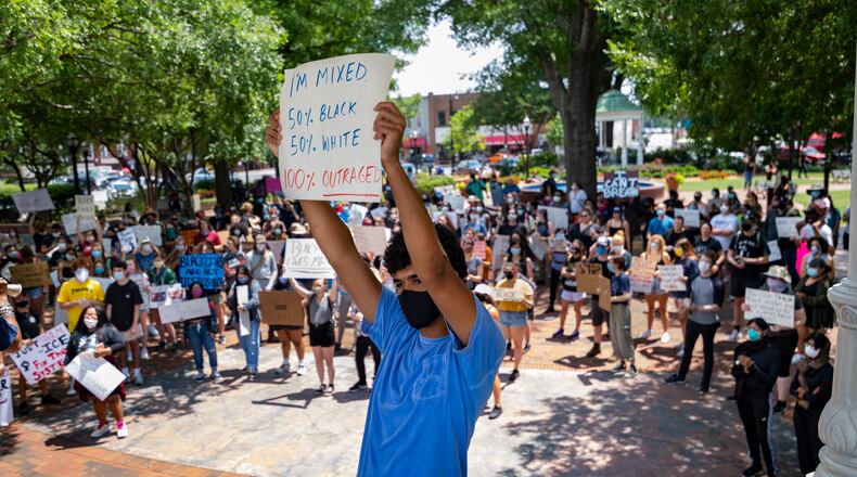 Walton High School student Joseph Fisher, 18, protests in Marietta Square on Wednesday.  JOHN AMIS FOR THE ATLANTA JOURNAL-CONSTITUTION
