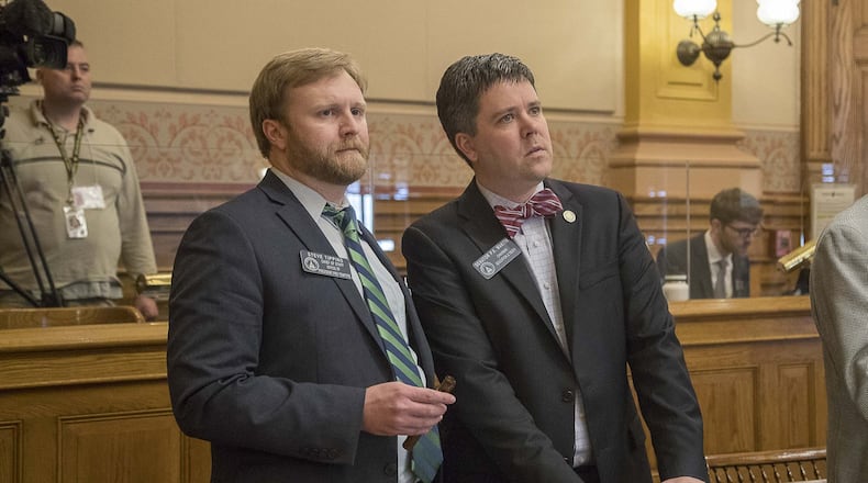 Georgia Sen. P.K. Martin of Lawrenceville, right, and Steve Tippins, the chief of staff to Senate President Pro Tem Butch Miller react Thursday as Lt. Gov. Geoff Duncan suspends the Senate’s session due to the coronavirus. (ALYSSA POINTER/ALYSSA.POINTER@AJC.COM)
