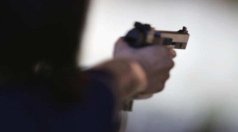 Stock photo of a hand holding a gun.