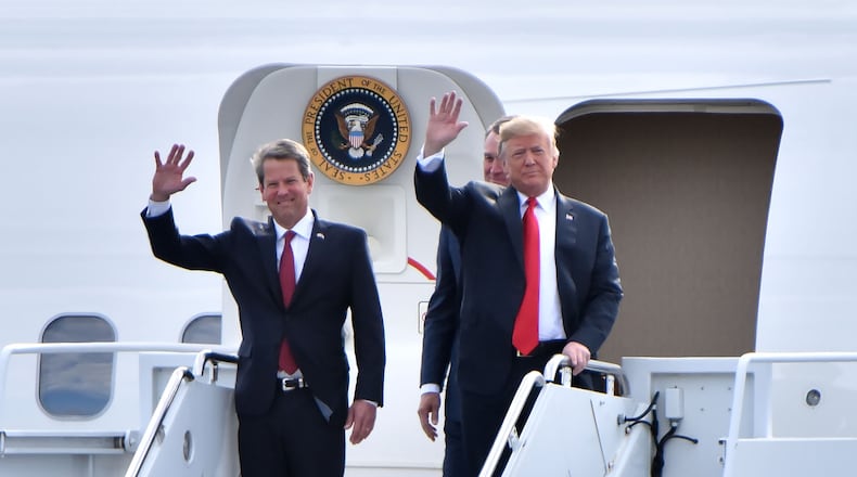 November 4, 2018 Macon - GOP gubernatorial candidate Brian Kemp and President Donald Trump wave from Air Force One as President Donald J. Trump arrives during President Donald J. Trump's Make America Great Again Rally to support Brian Kemp at Middle Georgia Regional Airport in MaconSunday, November 4, 2018. HYOSUB SHIN / HSHIN@AJC.COM