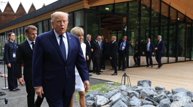 U.S. President Donald Trump walks after posing for a family photo photograph during a gala dinner as part of the G7 summit, in Evian-les-Bains, France, Tuesday June 16, 2026. (Ludovic Marin/Pool Photo via AP)