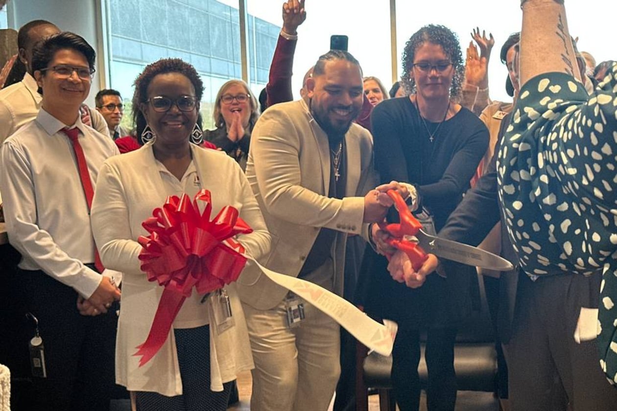 Holly Ireland, interim director of the HOPE Center, joins health care professionals and community members in unveiling the clinic’s new location on Thursday, Jan. 9, 2025. The new space on Arkwright Road promises to bring new services and more privacy to patients. (Photo Courtesy of Lucinda Warnke/The Telegraph)