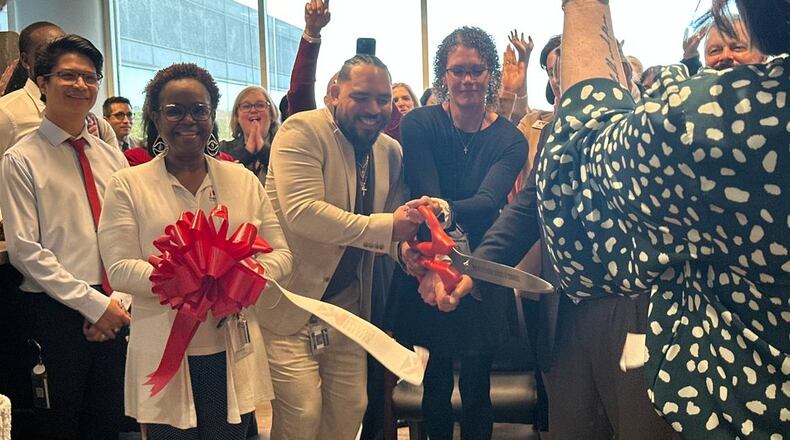 Holly Ireland, interim director of the HOPE Center, joins health care professionals and community members in unveiling the clinic’s new location on Thursday, Jan. 9, 2025. The new space on Arkwright Road promises to bring new services and more privacy to patients. (Photo Courtesy of Lucinda Warnke/The Telegraph)