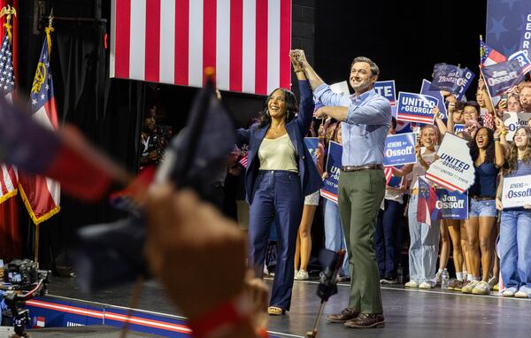 Democratic gubernational nominee Keisha Lance Bottoms and U.S. Senator Jon Ossoff raise their hands together to conclude their combined rally in the Georgia Theatre in Athens on Sunday, Sept. 13, 2026. (Felix Scheyer for the AJC)