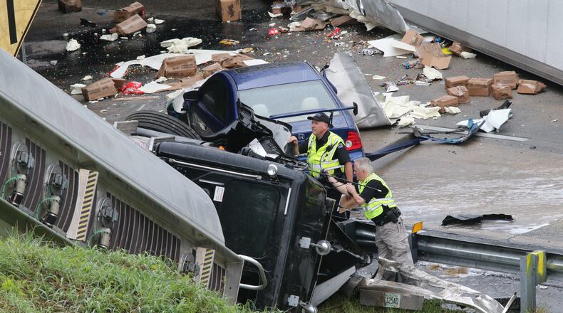 I-285 crash: Road closures may last through rush hourhttp://www.myajc.com/gallery/news/i-285-crash-trucks-plunge-interstate-ga-400/gCXDJ/
