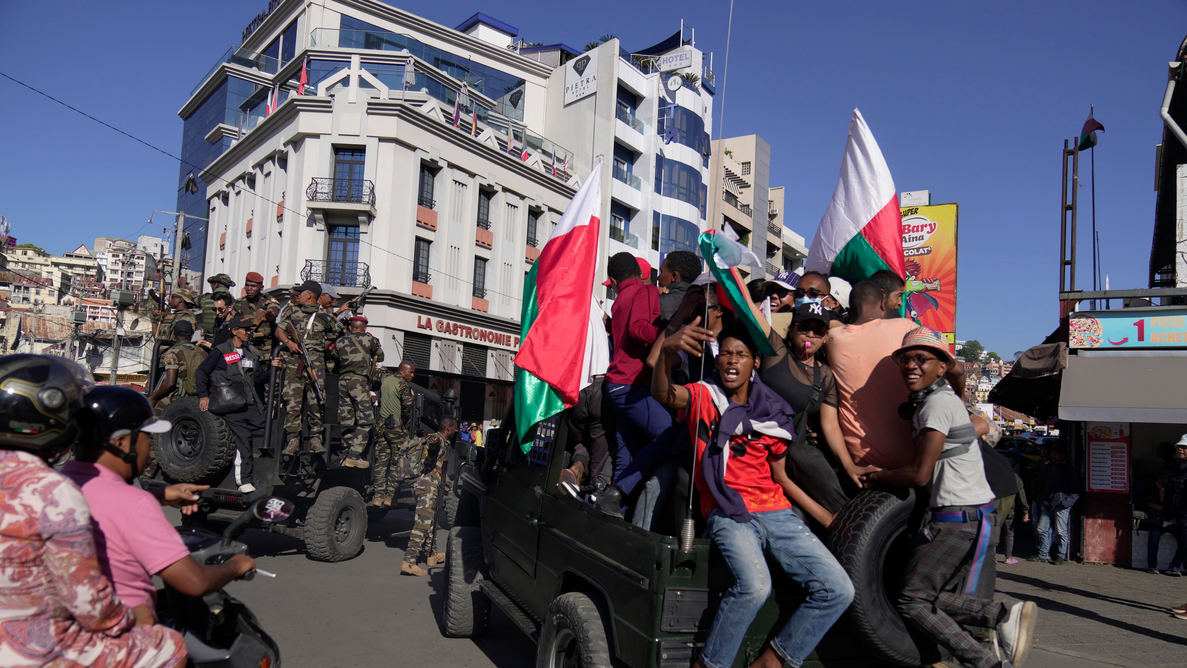 Troops loyal to CAPSAT military unit commander Col. Michael Randrianirina make their way to the Presidency to announce that the armed forces are taking control of the country in Antananarivo, Madagascar, Tuesday, Oct. 14, 2025. (AP Photo/ Brian Inganga)