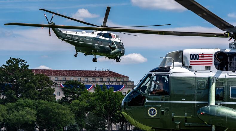 Marine One, left, with President Donald Trump aboard, lifts off from the Ellipse, Tuesday, Aug. 4, 2026, in Washington. (AP Photo/Alex Brandon)