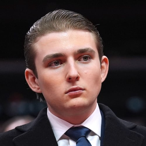 FILE - Barron Trump watches as his father, President Donald Trump attends an indoor Presidential Inauguration parade event at Capital One Arena, in Washington, Jan. 20, 2025. (AP Photo/Evan Vucci, File)