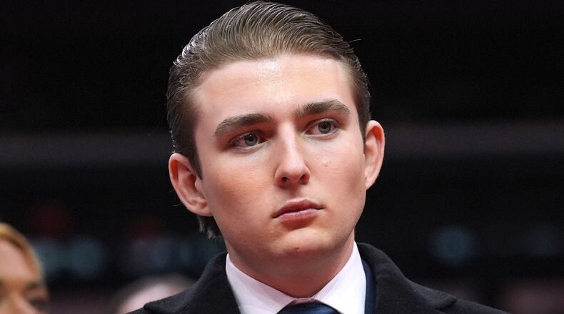 FILE - Barron Trump watches as his father, President Donald Trump attends an indoor Presidential Inauguration parade event at Capital One Arena, in Washington, Jan. 20, 2025. (AP Photo/Evan Vucci, File)