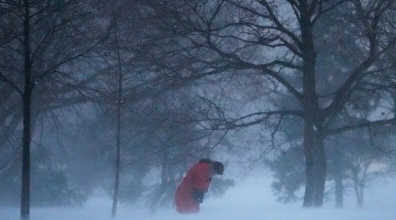 A person walks against the blowing snow Saturday, Nov. 29, 2025, in Chicago. (AP Photo/Kiichiro Sato)