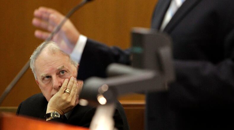 Former Governor Roy Barnes, an attorney for the plaintiff, listens to Thomas Bundy present his rebuttal argument in June 1012 at a hearing on a lawsuit about the school district halting contributions to a supplemental employee retirement fund. BOB ANDRES / BANDRES@AJC.COM