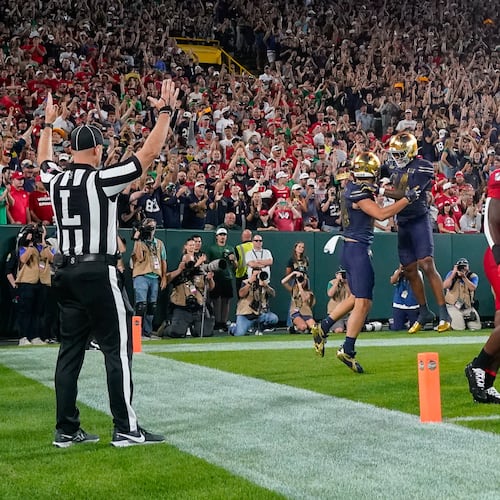 Notre Dame tight end James Flanigan, center left, and teammate Micah Gilbert, center right, celebrate a touchdown during the first half of an NCAA college football game against Wisconsin Sunday, Sept. 6, 2026, in Green Bay, Wis. (AP Photo/Kayla Wolf)