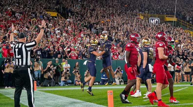 Notre Dame tight end James Flanigan, center left, and teammate Micah Gilbert, center right, celebrate a touchdown during the first half of an NCAA college football game against Wisconsin Sunday, Sept. 6, 2026, in Green Bay, Wis. (AP Photo/Kayla Wolf)