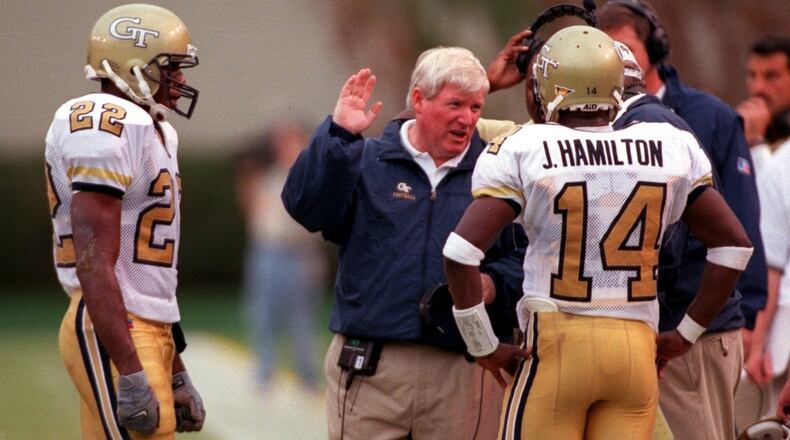 Georgia Tech coach George O'Leary talks with quarterback Joe Hamilton and wide receiver Dez White in the third quarter of the game between Georgia Tech and North Carolina at Bobby Dodd Stadium on Saturday, October 9, 1999. (LEVETTE BAGWELL/AJC File)