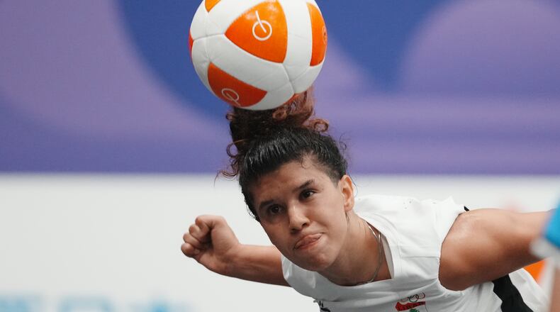 Lebanon's Kamar Dandal controls the ball during the women's singles bronze-medal teqball match against Cambodia's Koemyean Dy at the Asian Games in Nagoya, Japan, Sunday, Sept. 20, 2026. (AP Photo/Lee Jin-man)