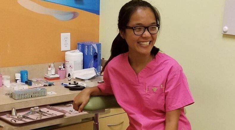 Niang Muang, pictured here shadowing a local dentist, has been accepted into dental school. (Courtesy of F.R.E.E.)