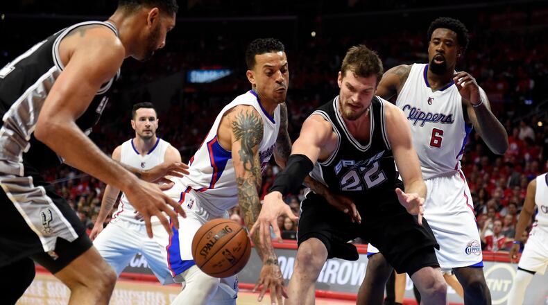 Apr 19, 2015; Los Angeles, CA, USA; San Antonio Spurs center Tiago Splitter (22) grabs a rebound against Los Angeles Clippers center DeAndre Jordan (6) and forward Matt Barnes (22) in game one of the first round of the NBA Playoffs at Staples Center. Mandatory Credit: Richard Mackson-USA TODAY Sports