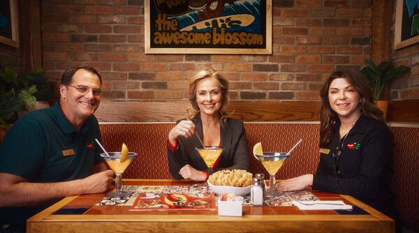 This undated image released by Chili's shows actors Andy Buckley, from left, Melora Hardin and Amy Pietz, who appeared in the TV series "The Office," posing at a soon-to-be opened Chili's in Dickson City, Pa. (Chili's via AP)