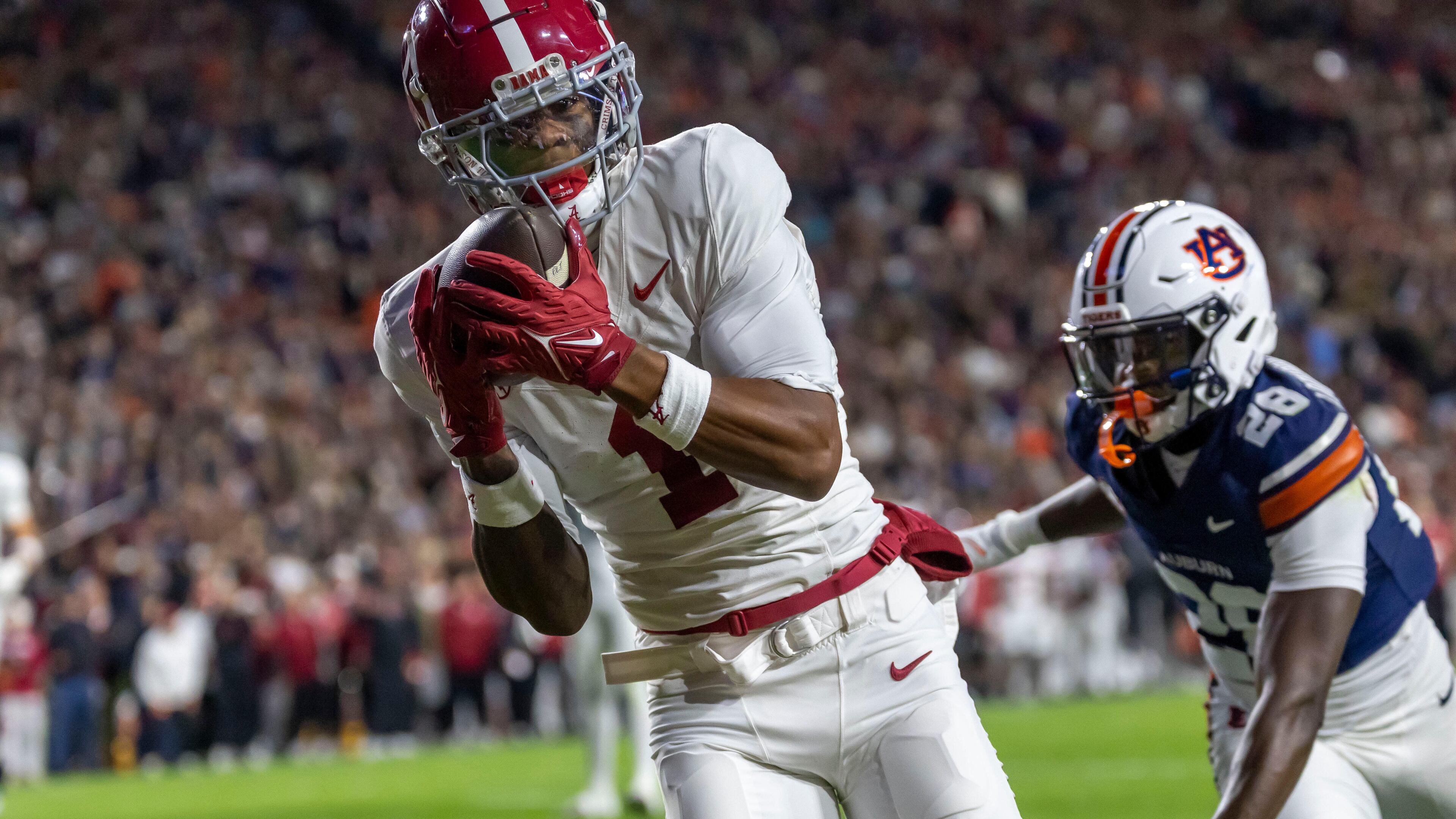 Alabama wide receiver Isaiah Horton, left, grabs a touchdown pass in front of Auburn defensive back Kensley Louidor-Faustin (28) during the first half of an NCAA college football game, Saturday, Nov. 29, 2025, in Auburn, Ala. (AP Photo/Vasha Hunt)